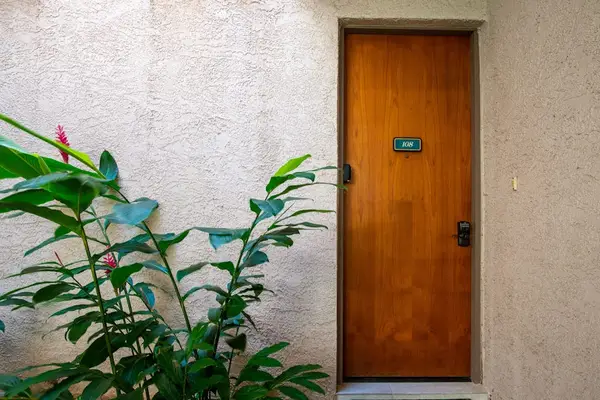 Private Front Door Entrance Framed by Tropical Red Ginger Plants
