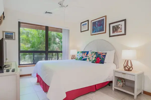 Sunlit Primary Bedroom Suite Featuring Tropical Greenery Views