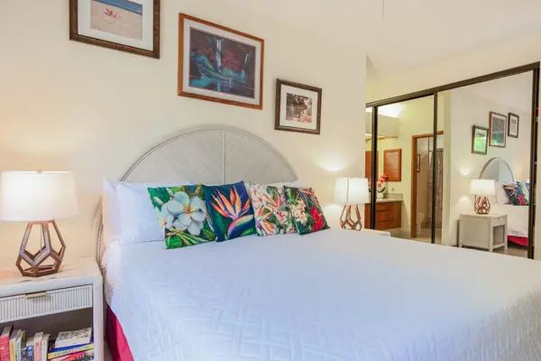 Plush King Bed Flanked by Nightstands & Mirrored Closet Doors