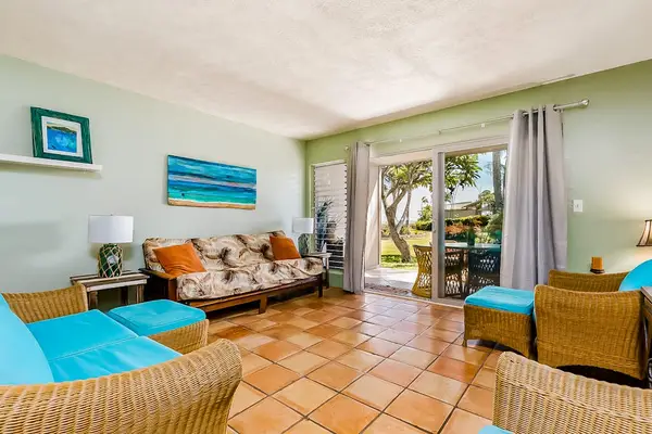 Bright living room with colorful seating and direct garden access