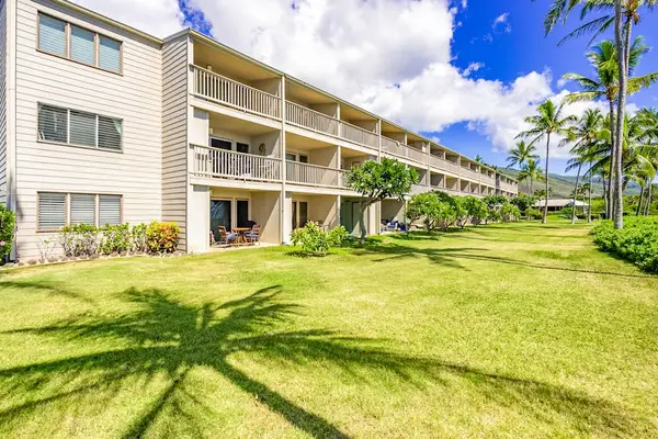 Spacious resort grounds frame multi-level accommodations beneath sunny island skies