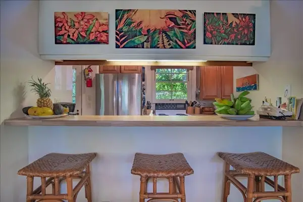 Spacious kitchen island provides additional seating and convenient workspace for guests