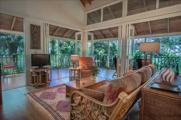 Living room features inviting seating television and bright natural light