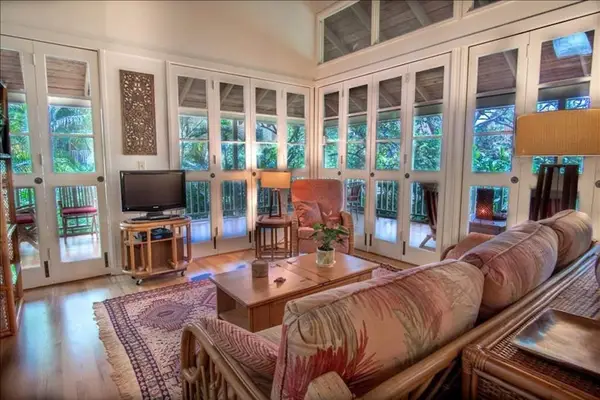 Comfortable living room features seating television and bright island views