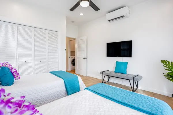 Bright bedroom with TV and workspace