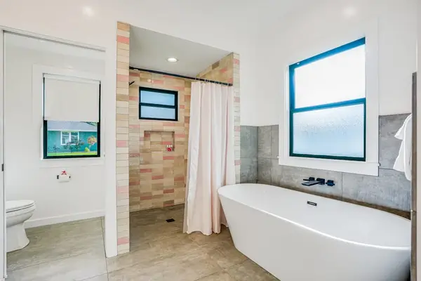 Bathroom featuring a soaking tub and shower