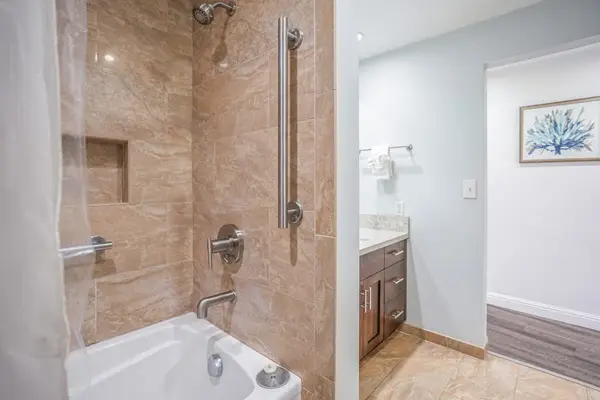 Spacious walk-in shower with bath tub offers a refreshing start to each morning