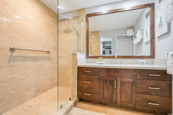 Refresh comfortably in this spacious bathroom with modern walk-in shower
