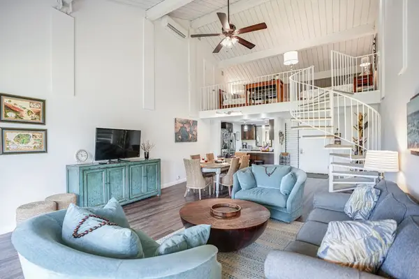 Spacious living area offers comfortable seating beneath soaring vaulted ceilings