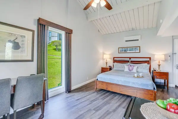 Relax in this airy bedroom with easy outdoor access nearby