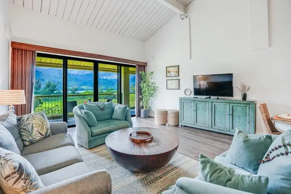 Relax in this airy living room surrounded by natural light