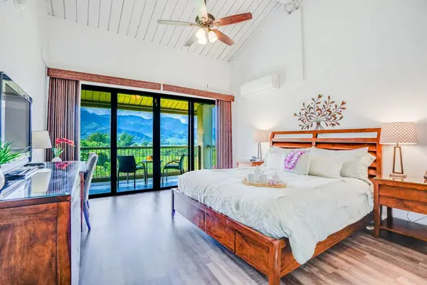 Rest peacefully in this bright bedroom with refreshing outdoor views