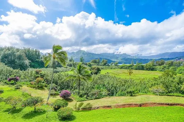 Sweeping green landscape offers peaceful views beneath bright island skies
