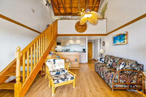 Island-inspired living room includes comfortable seating and decorative artwork