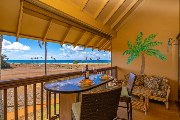 Covered patio offers ocean views with comfortable outdoor dining space