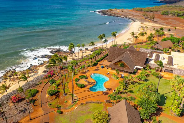 Aerial resort view highlights coastline pool tropical surroundings and scenery