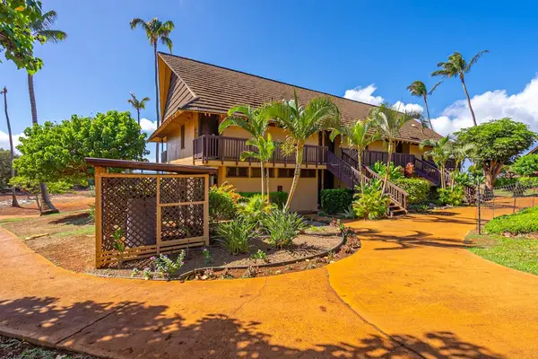 Resort cottage exterior welcomes guests with palms paths and sunshine