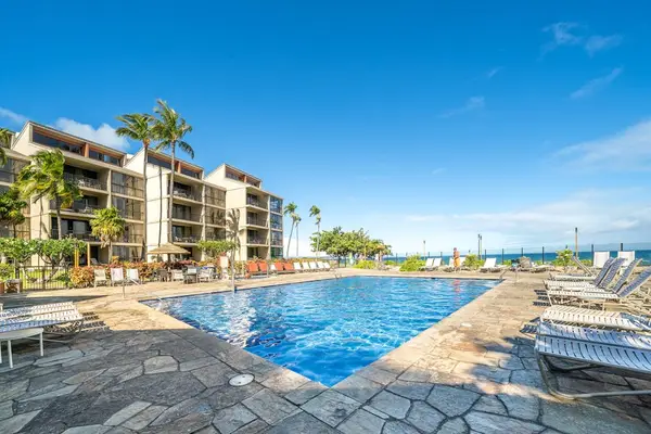Another view of the resort pool, surrounded by tropical landscaping.