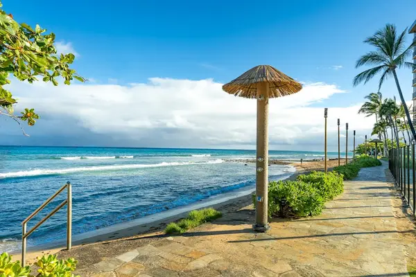 Scenic beachfront path with a shaded palapa, right outside the property.