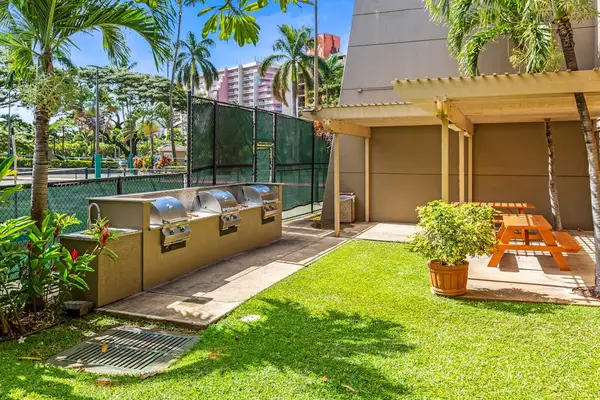 BBQ grill area with picnic seating, great for outdoor dining.