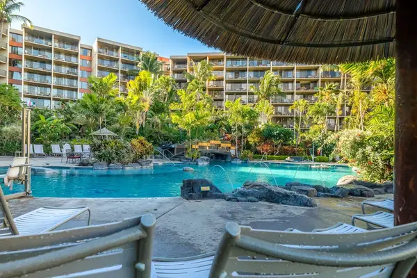 Resort pool area shaded by a palapa, perfect for a break from the sun.