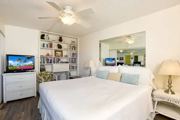 Master bedroom with king bed, flat screen tv and an ensuite bathroom.