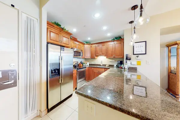 Fully equipped kitchen with granite countertops and modern appliances