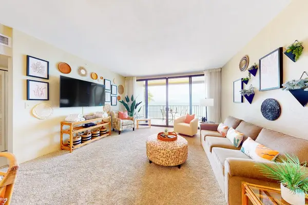 Bright living room with comfortable seating and direct ocean views.
