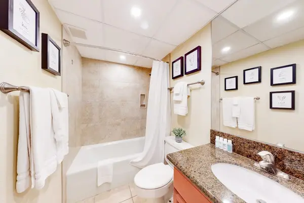 Guest room's full bathroom with a soaking tub and dual vanity.