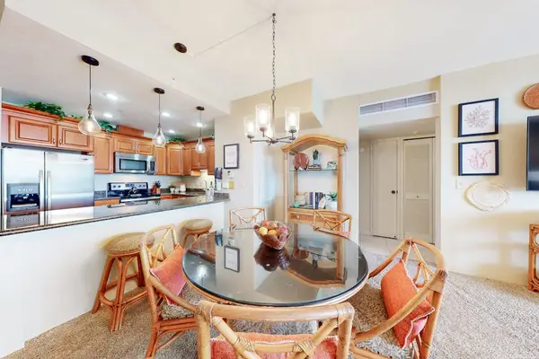 Round dining table with seating, open to the kitchen and living area.