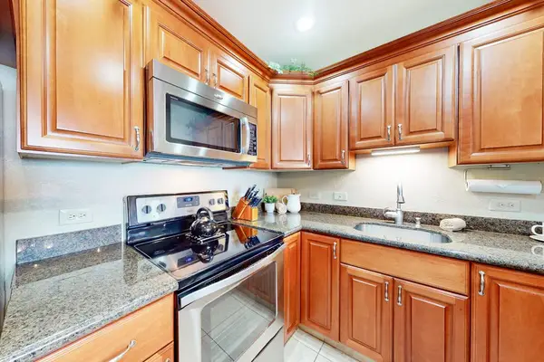 Kitchen with a gas range and ample cabinet storage.