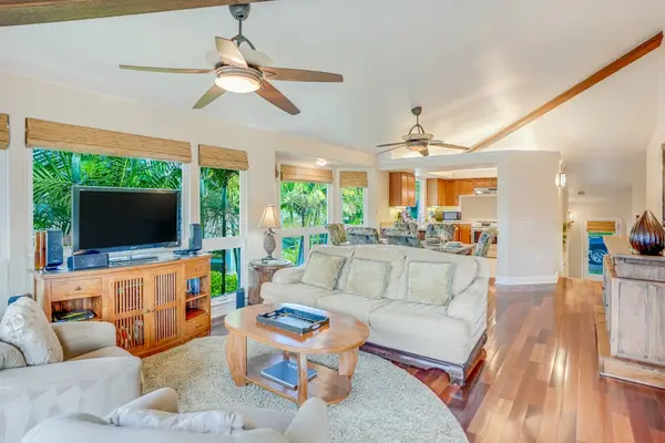 Living room with lots of natural light streaming in from the numerous windows.