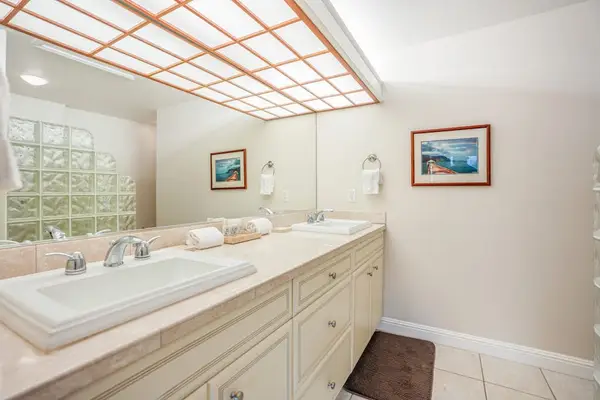 Guest ensuite bathroom with double sinks and a large walk-in shower.