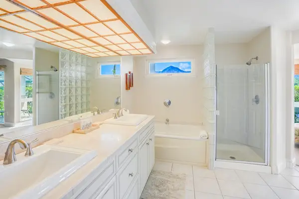 Large ensuite master bathroom with double sinks, garden tub and a walk in shower.