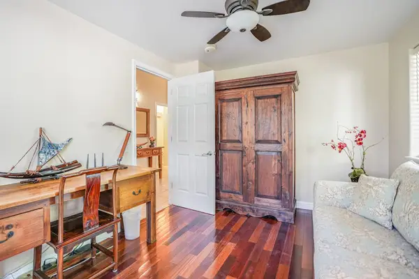 Office with a desk to handle anything you need to while away with floor to ceiling windows.