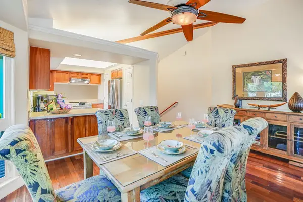 Dining room with seating for six, open to the living room and kitchen.