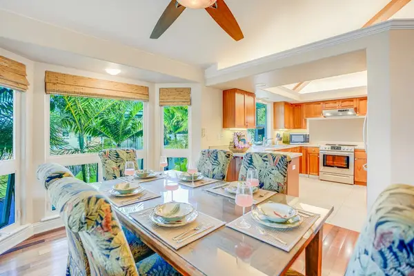 Dining room with seating for six, open to the living room and kitchen.