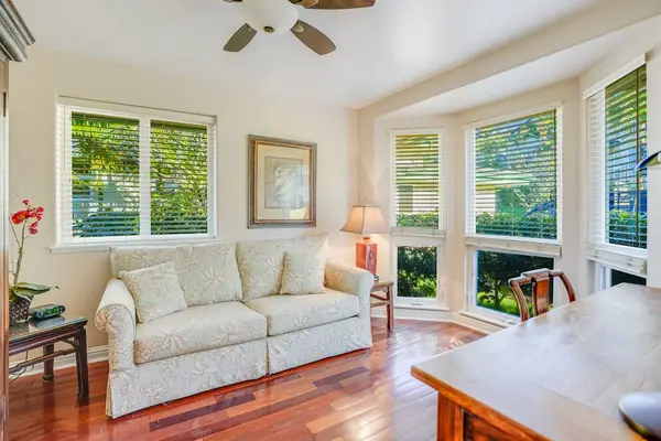 Office with a desk to handle anything you need to while away with floor to ceiling windows.