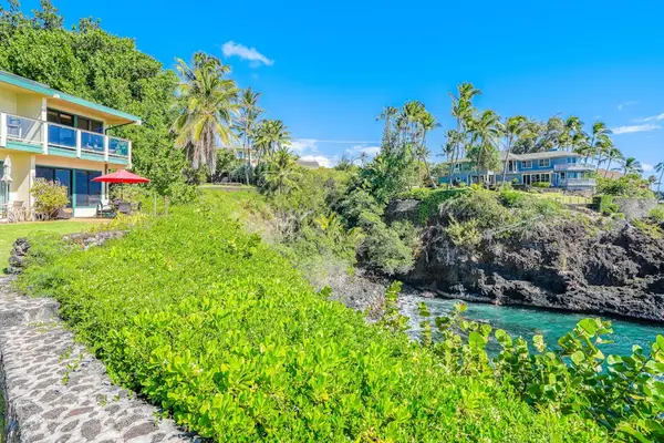 Relax in the peaceful backyard surrounded by tropical landscaping