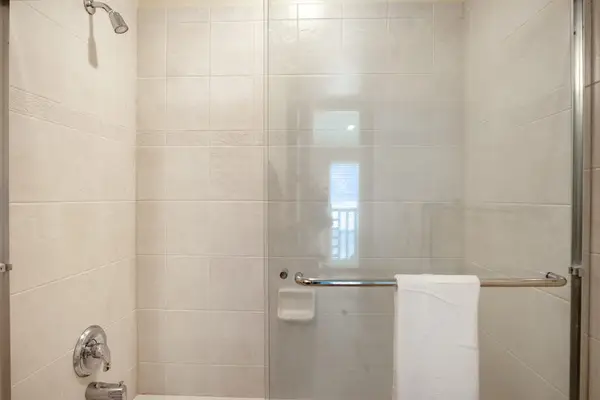 Clean Walk-In Shower with Fresh Bath Linens & Tile Wall Finish