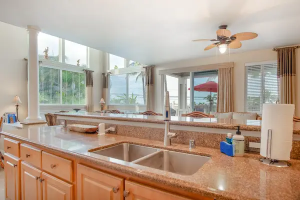 Wide Kitchen View with Expansive Countertops & Living Area Flow