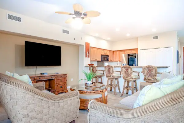 Open-Concept Living Room & Kitchen with Mounted TV & Breakfast Bar