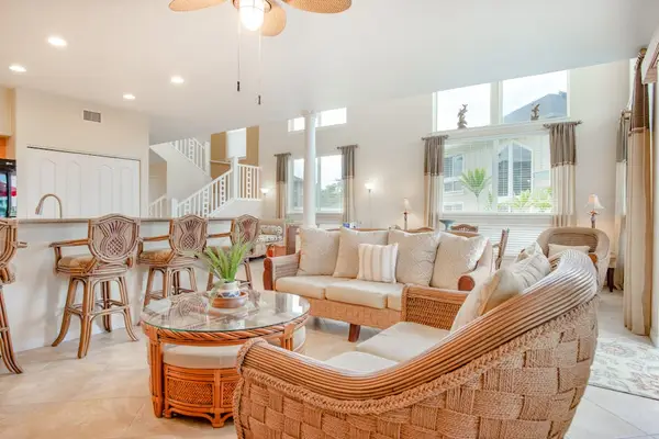 Open-Concept Living Room with Wicker Seating & Kitchen Bar View