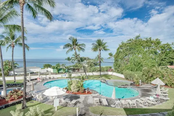 Elevated View of Resort Swimming Pool Complex & Ocean Background