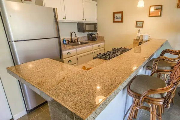 Functional kitchen with extra dining chairs creating a comfortable gathering space indoors