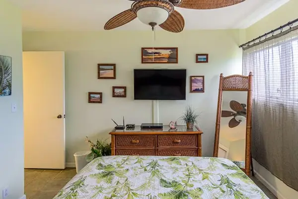 Comfortable queen bedroom with television and fresh linens for restful relaxing stays