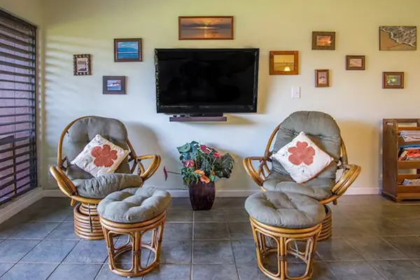 Cozy seating area featuring chairs, ottoman, and television for guest entertainment
