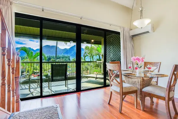 Dining area opens onto views, tropical greenery, and natural light
