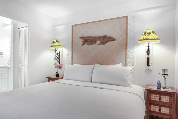 Symmetrical Bedroom View with Warm Bedside Lighting & Crisp Linens