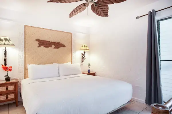 Primary Bedroom Suite with Natural Wood Headboard & Private Patio Access